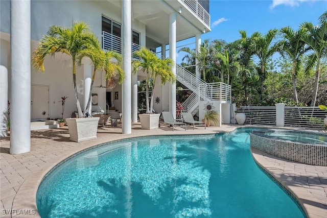 view of pool with a pool with connected hot tub, stairs, and a patio area