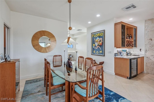 dining area featuring light tile patterned flooring, visible vents, recessed lighting, wet bar, and beverage cooler