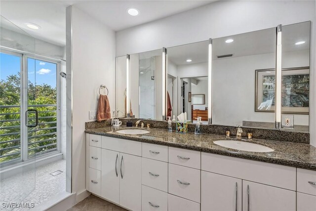 full bath with double vanity, a sink, an enclosed shower, and recessed lighting
