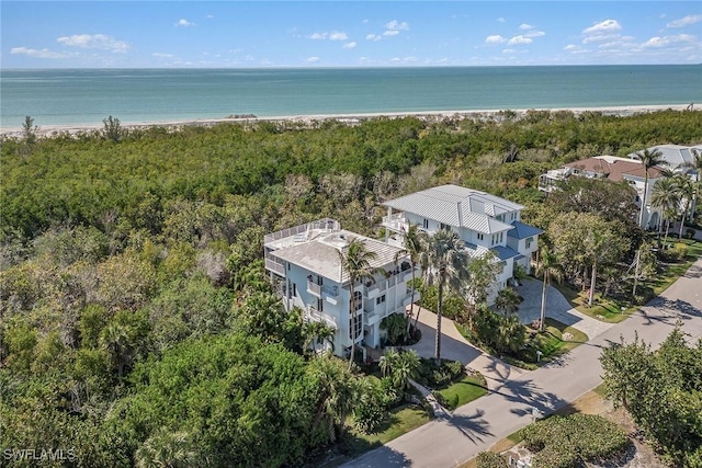 birds eye view of property featuring a beach view and a water view