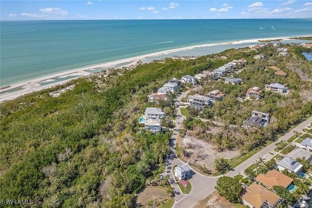 birds eye view of property featuring a water view and a view of the beach