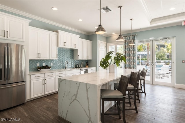 6953 Avalon Cir Unit 1804, Naples, FL 34112 - kitchen with stainless steel appliances, french doors, white cabinetry, recessed lighting, and crown molding