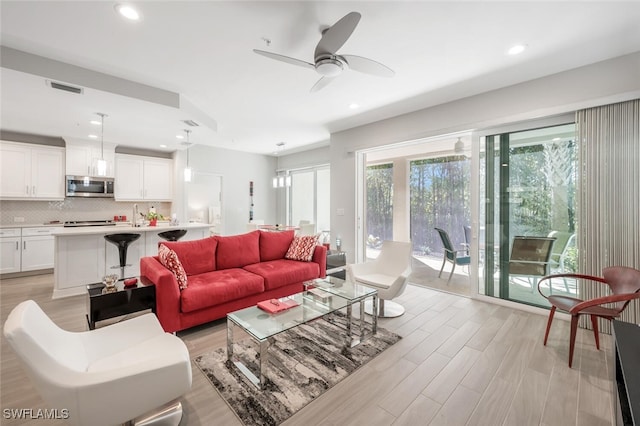 6953 Avalon Cir Unit 1804, Naples, FL 34112 - living room with a ceiling fan, light wood-style floors, and recessed lighting