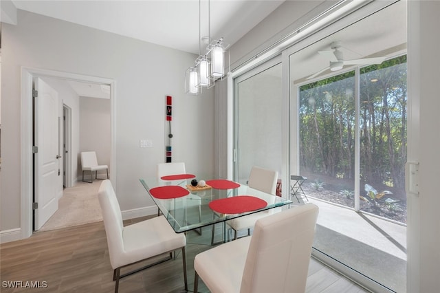 6953 Avalon Cir Unit 1804, Naples, FL 34112 - dining room featuring wood finished floors, ceiling fan, and baseboards