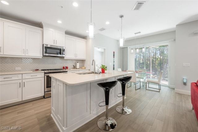 6953 Avalon Cir Unit 1804, Naples, FL 34112 - kitchen featuring stainless steel appliances, a sink, baseboards, backsplash, and recessed lighting