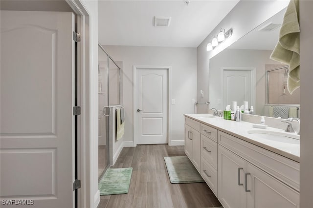 6953 Avalon Cir Unit 1804, Naples, FL 34112 - full bath featuring wood finished floors, a shower stall, double vanity, and baseboards