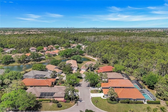 birds eye view of property with a view of trees, a residential view, and a water view