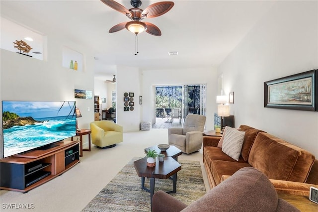 carpeted living area featuring visible vents and ceiling fan