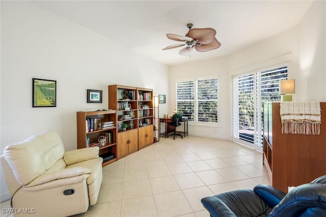 interior space with ceiling fan, baseboards, and light tile patterned floors