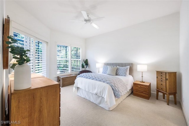 bedroom featuring ceiling fan and light carpet
