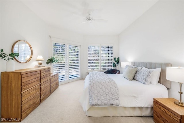bedroom featuring access to outside, light carpet, and a ceiling fan
