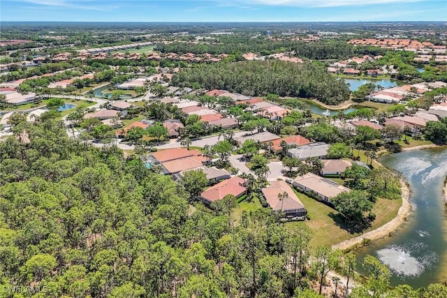 birds eye view of property with a residential view and a water view