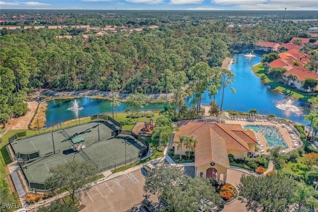drone / aerial view with a water view and a view of trees