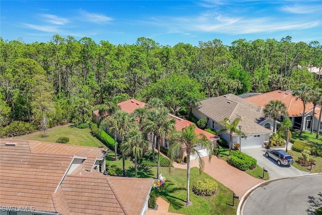 drone / aerial view featuring a wooded view