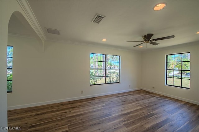 20587 Charing Cross Cir, Estero, FL 33928 - unfurnished room with plenty of natural light, wood finished floors, arched walkways, crown molding, and a ceiling fan