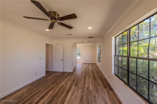 20587 Charing Cross Cir, Estero, FL 33928 - empty room featuring arched walkways, wood finished floors, ornamental molding, baseboards, and recessed lighting