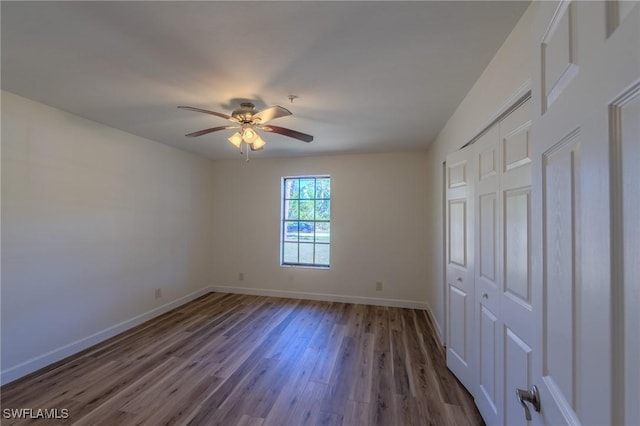 20587 Charing Cross Cir, Estero, FL 33928 - unfurnished bedroom featuring wood finished floors, baseboards, a closet, and ceiling fan