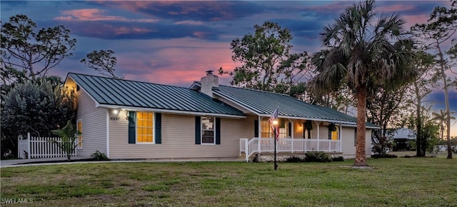 20587 Charing Cross Cir, Estero, FL 33928 - single story home with covered porch, a chimney, a standing seam roof, and metal roof