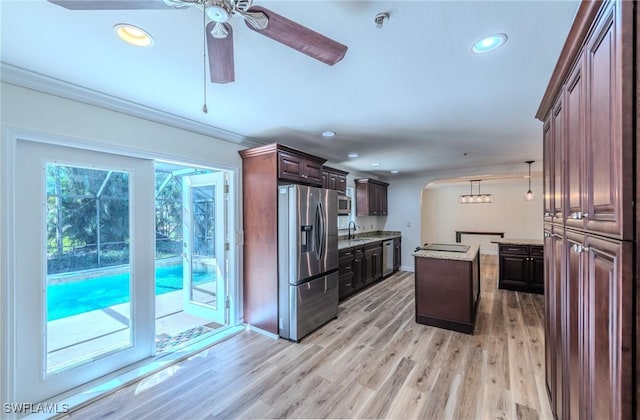 20587 Charing Cross Cir, Estero, FL 33928 - kitchen with stainless steel appliances, ceiling fan, arched walkways, a center island, and ornamental molding