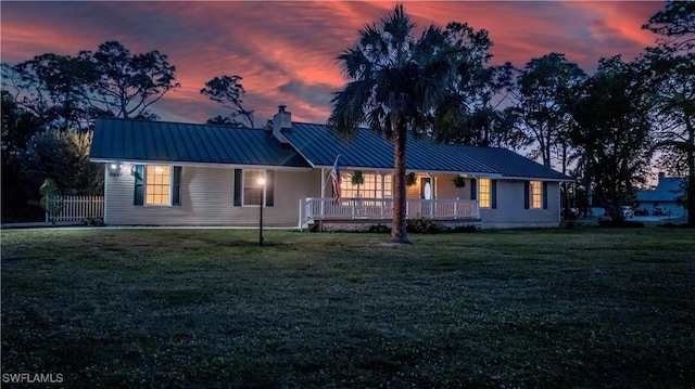 20587 Charing Cross Cir, Estero, FL 33928 - view of front of home with a chimney, a standing seam roof, metal roof, and a porch