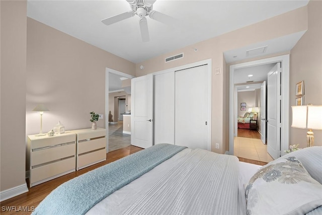 24031 Via Castella Dr Unit 1302, Bonita Springs, FL 34134 - bedroom featuring wood finished floors, baseboards, visible vents, ceiling fan, and a closet