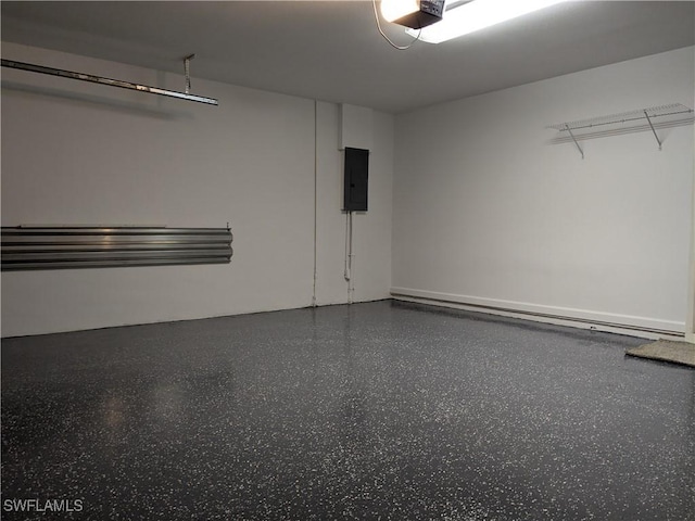 garage with a garage door opener and electric panel