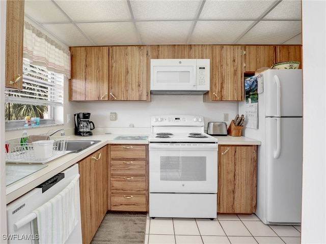 499 Forest Lakes Blvd Unit 308, Naples, FL 34105 - kitchen with white appliances, light countertops, a drop ceiling, and light tile patterned floors