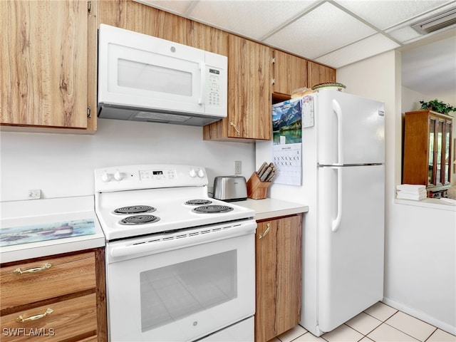 499 Forest Lakes Blvd Unit 308, Naples, FL 34105 - kitchen featuring light countertops, brown cabinets, white appliances, visible vents, and a paneled ceiling
