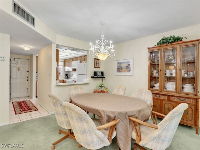 499 Forest Lakes Blvd Unit 308, Naples, FL 34105 - dining room featuring light tile patterned flooring, visible vents, an inviting chandelier, and light colored carpet
