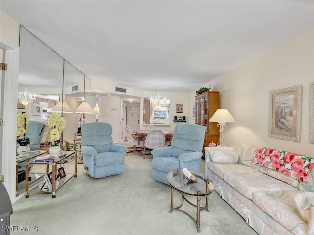 499 Forest Lakes Blvd Unit 308, Naples, FL 34105 - carpeted living room featuring visible vents and a notable chandelier