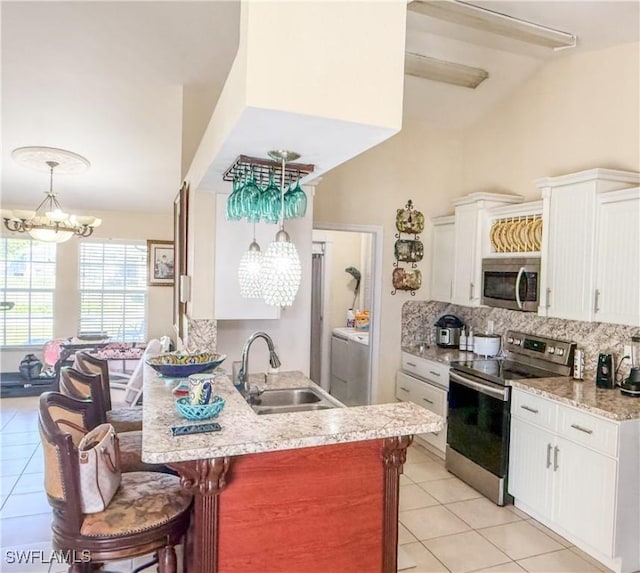 3911 9th St SW, Lehigh Acres, FL 33976 - kitchen featuring an inviting chandelier, a sink, light tile patterned floors, and stainless steel appliances