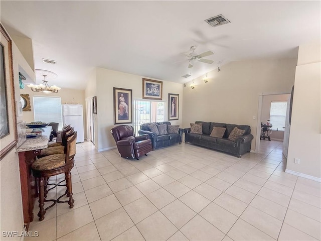 3911 9th St SW, Lehigh Acres, FL 33976 - living area featuring visible vents, light tile patterned floors, lofted ceiling, and ceiling fan with notable chandelier