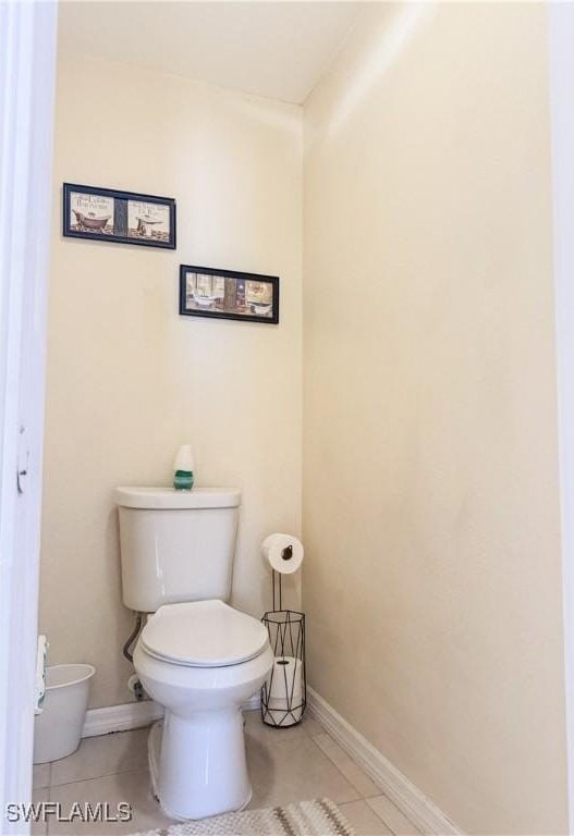 3911 9th St SW, Lehigh Acres, FL 33976 - bathroom featuring baseboards, tile patterned flooring, and toilet