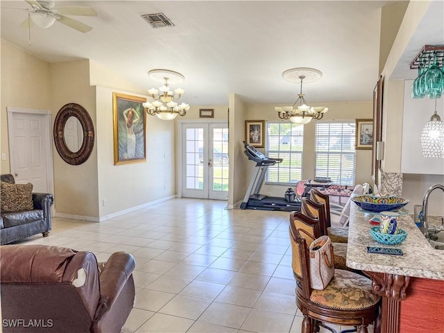 3911 9th St SW, Lehigh Acres, FL 33976 - living room featuring french doors, ceiling fan with notable chandelier, baseboards, light tile patterned floors, and visible vents