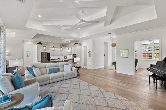 living area with recessed lighting, coffered ceiling, light wood-type flooring, baseboards, and ceiling fan