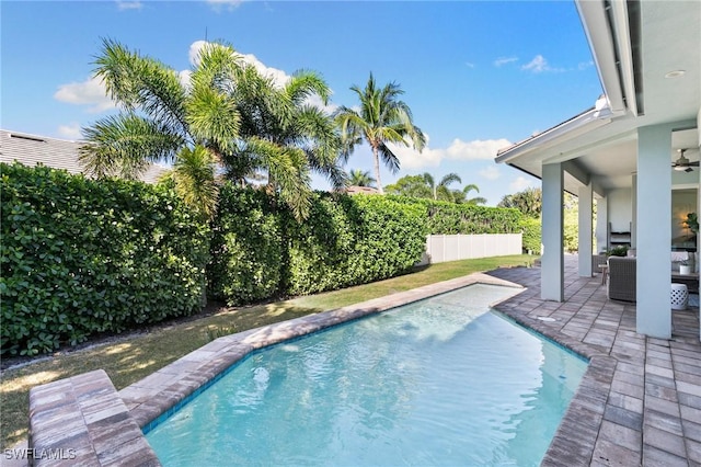 view of pool featuring a patio area, a ceiling fan, a fenced in pool, and a fenced backyard