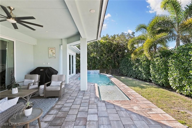 view of swimming pool with a fenced in pool, a fenced backyard, ceiling fan, grilling area, and a patio