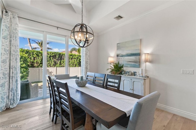 dining area with light wood-type flooring, baseboards, visible vents, a chandelier, and ornamental molding