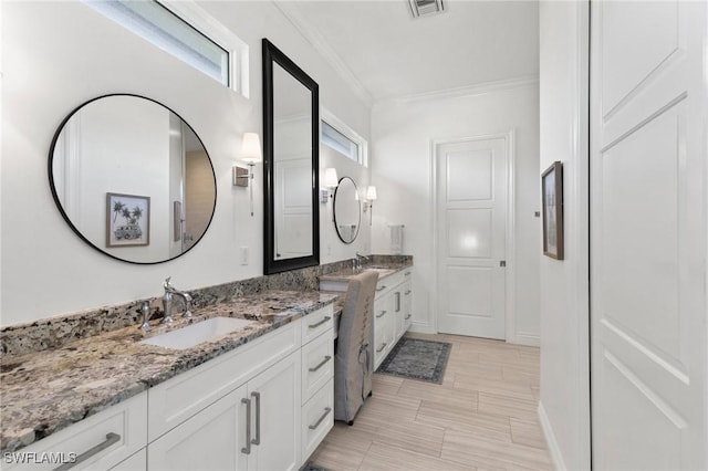 full bathroom featuring visible vents, plenty of natural light, vanity, and ornamental molding