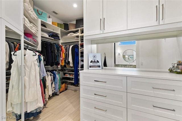 spacious closet with light wood-style flooring and visible vents