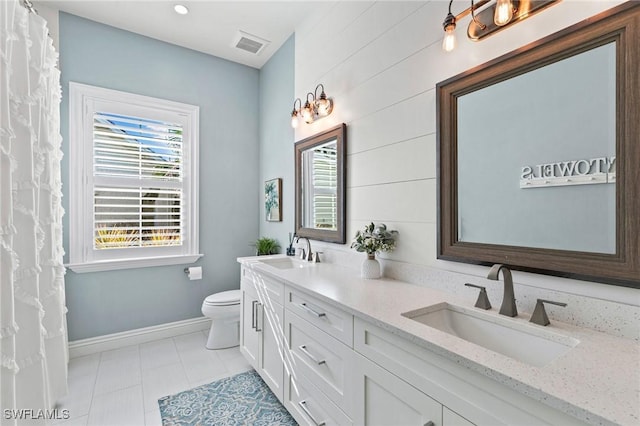 full bathroom with a wealth of natural light, a sink, and toilet
