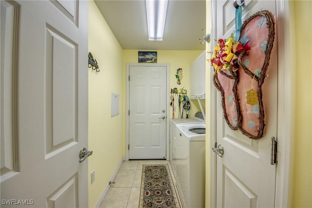 2626 Astwood Ct, Cape Coral, FL 33991 - washroom featuring washing machine and dryer, cabinet space, and light tile patterned floors