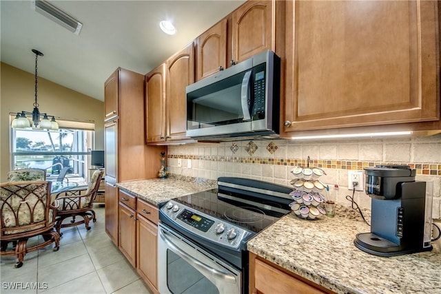 2626 Astwood Ct, Cape Coral, FL 33991 - kitchen featuring light tile patterned flooring, appliances with stainless steel finishes, hanging light fixtures, lofted ceiling, and visible vents