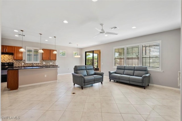 6068 Triumph Ln, Ave Maria, FL 34142 - living area featuring light tile patterned floors, visible vents, baseboards, and a ceiling fan