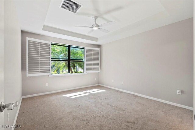 6068 Triumph Ln, Ave Maria, FL 34142 - empty room featuring carpet, a raised ceiling, a ceiling fan, and visible vents