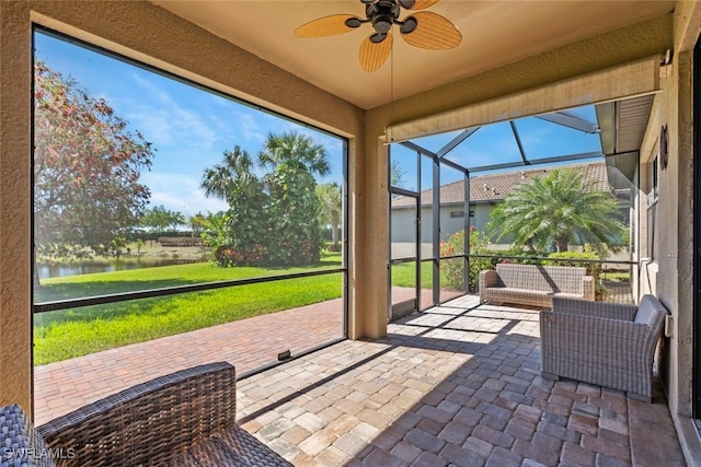 6068 Triumph Ln, Ave Maria, FL 34142 - unfurnished sunroom featuring a ceiling fan and a water view