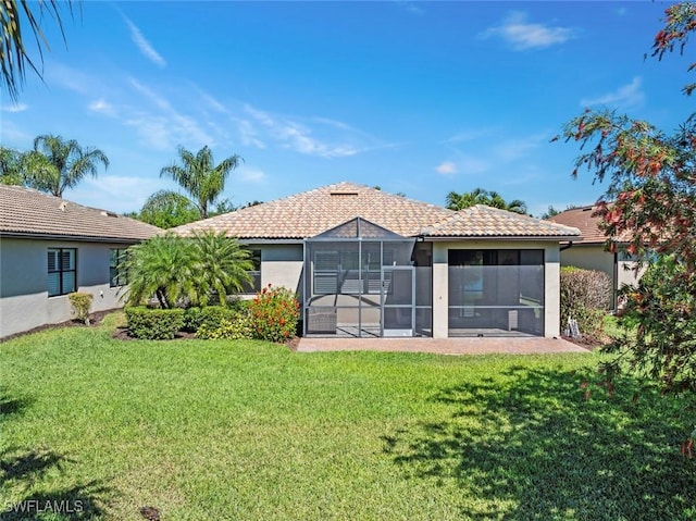 6068 Triumph Ln, Ave Maria, FL 34142 - back of house featuring stucco siding, a lawn, a lanai, and a tiled roof