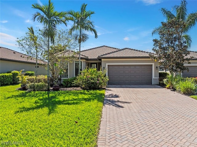 6068 Triumph Ln, Ave Maria, FL 34142 - view of front of property featuring a tile roof, decorative driveway, a garage, and stucco siding
