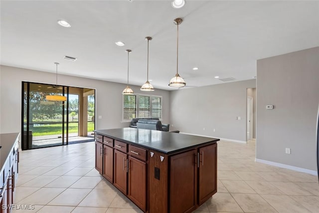 6068 Triumph Ln, Ave Maria, FL 34142 - kitchen with dark countertops, visible vents, recessed lighting, and light tile patterned flooring