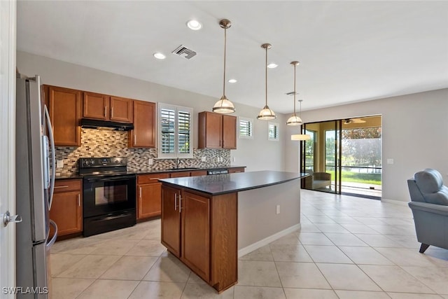 6068 Triumph Ln, Ave Maria, FL 34142 - kitchen featuring visible vents, freestanding refrigerator, black range with electric stovetop, under cabinet range hood, and dark countertops